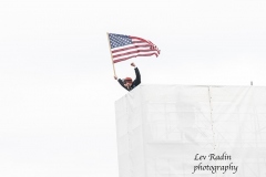 Washington, DC - January 6, 2021: Pro-Trump protester seen on top of bleeches at Capitol building built for Inauguration of 46th Presiden Joe Biden