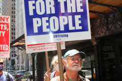 Member of the Professional Staff Congress the  college union that represents professors and college staff, protest in front of New York's City Hall.