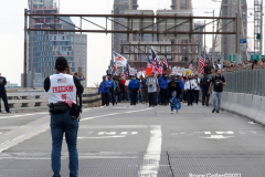 New York,  12,000 N.Y.C.  Municipal employees (police,fire,sanitation,teachers) protest  the  
Mandate to get vaccinated by October 29, 2021 or be put on unpaid leave. The protesters walked across the Brooklyn Bridge to City Hall.