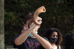 Group of observant jews protest in front of United States Senator Charles Schumer's apartment building on the eve of the Holiest of jewish holidays Yom Kippur. The protestors want him to try and delay the confirmation hearing for Supreme court justice until after the election. Some protestors blow the ceremonial shofar (Rams Horn).