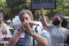 Group of observant jews protest in front of United States Senator Charles Schumer's apartment building on the eve of the Holiest of jewish holidays Yom Kippur. The protestors want him to try and delay the confirmation hearing for Supreme court justice until after the election. Some protestors blow the ceremonial shofar (Rams Horn).