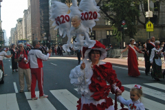 A woman holds a banner in tribute to Saint Pope John Paul II who was born in Poland.  The banner was originally intended to mark the popes 100 birthday year but COVID forced the cancellation of the 2020 parade.