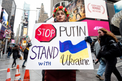 February 24, 2022 - New York, NY, United States: Woman with a sign with the words "Stop Putin, Stand with Ukraine" at a "Stop Putin" rally organized as a response to the war in Ukraine.