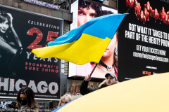 February 24, 2022 - New York, NY, United States: Man with a Ukrainian flag at a "Stop Putin" rally organized as a response to the war in Ukraine.