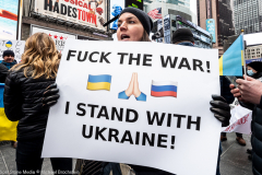 February 24, 2022 - New York, NY, United States: Woman with a sign with the words "F**k the war! I stand with Ukraine!" at a "Stop Putin" rally organized as a response to the war in Ukraine.