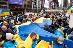 February 24, 2022 - New York, NY, United States: Demonstrators holding a very large Ukrainian flag at a "Stop Putin" rally organized as a response to the war in Ukraine.