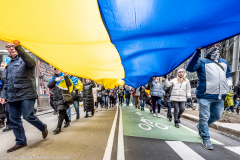 February 24, 2022 - New York, NY, United States: Demonstrators holding a very large Ukrainian flag at a "Stop Putin" rally organized as a response to the war in Ukraine.