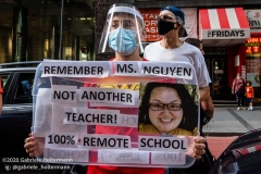 A teachers holds a sign remembering her colleague who died of COVID-19, while a coalition of activists, educators, parents, and students protest to stop the in-person reopening of  New York City public schools amidst the COOVID-19 pandemic in New York City on August 3, 2020. (Photo by Gabriele Holtermann/Sipa USA)