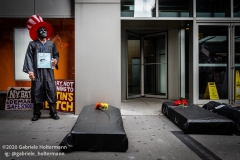 A protestor stands next to two coffins representing the danger of opening schools, while coalition of activists, educators, parents, and students protest to stop the in-person reopening of  New York City public schools amidst the COOVID-19 pandemic in New York City on August 3, 2020. (Photo by Gabriele Holtermann/Sipa USA)