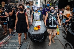 Protesters carry a makeshift coffin representing potential death students and educators face, while a coalition of activists, educators, parents, and students protest to stop the in-person reopening of  New York City public schools amidst the COOVID-19 pandemic in New York City on August 3, 2020. (Photo by Gabriele Holtermann/Sipa USA)