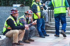 Workers sit and have a rest before the big task of tree assembly with food donated by Rockefeller Center.

The Rockefeller Christmas Tree arrived at Rockefeller Plaza, Manhattan, NYC on the morning of November 13, 2021. 
Spectators flocked to watch the spectacle as well as those involved in the assembly and press after last year’s event was restricted due to COVID.
The impressive 12 ton and 85 year old tree is a Norway Spruce, donated by the PRICE family from Elkton, Maryland. This is the first Maryland tree that has ever been chosen in this tradition as the Rockefeller Center Tree.
 (C) Bianca Otero. NYC. November 13, 2021.