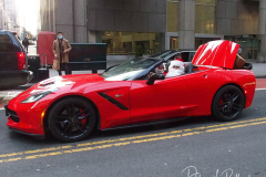 Santa Claus rides in a Red Corvette down 42nd Street with a trunk full of presents in New York City on 24 Dec 2021  .