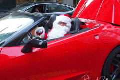 Santa Claus rides in a Red Corvette down 42nd Street with a trunk full of presents in New York City on 24 Dec 2021  .