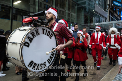 The brass band "Dark Tide" entertains the crowd during NYC Santa Con 2021 in New York, NY, on Dec. 11, 2021. (Photo by Gabriele Holtermann/Sipa USA)