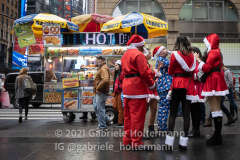 A group of "Santas" take a break from Santa Con 2021 in New York, NY, on Dec. 11, 2021. (Photo by Gabriele Holtermann/Sipa USA)