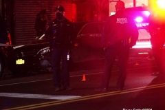 New York-  person shot on the conner of East 19th Street and Avenue M. in the Midwood section of Brooklyn. Police from the 70th precinct investigate the shooting. Red markers indicate where shell casing lay on the ground.