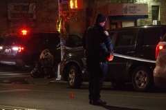 New York-  person shot on the conner of East 19th Street and Avenue M. in the Midwood section of Brooklyn. Police from the 70th precinct investigate the shooting. Red markers indicate where shell casing lay on the ground.