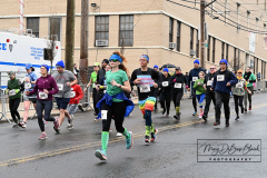 Staten Island St Patrick’s Day Parade
Sunday, March 06, 2022
Foret Avenue
West Brighton, Staten Island, NY
For Credit:  Mary DiBiase Blaich

The annual St Patrick’s Day Parade returned to Staten Island after a covid absence last year.  Controversy surrounded the event with the decision by the parade organizers to not allow LGBTQ groups to march.  The banned groups held a press conference prior to the parade.  In conduction with the parade, there is always a one mile race that precedes the parade.  It went on, but many racers ran in a second race in support of the banned groups.  
The weather was warm, but mixed with clouds, rain and sun.  Only two elected officials participated… Boro President Vito Fossella in a bright green sweater, and Congresswoman Nicole Malliotakis in a green Ireland sweater.