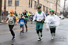 Staten Island St Patrick’s Day Parade
Sunday, March 06, 2022
Foret Avenue
West Brighton, Staten Island, NY
For Credit:  Mary DiBiase Blaich

The annual St Patrick’s Day Parade returned to Staten Island after a covid absence last year.  Controversy surrounded the event with the decision by the parade organizers to not allow LGBTQ groups to march.  The banned groups held a press conference prior to the parade.  In conduction with the parade, there is always a one mile race that precedes the parade.  It went on, but many racers ran in a second race in support of the banned groups.  
The weather was warm, but mixed with clouds, rain and sun.  Only two elected officials participated… Boro President Vito Fossella in a bright green sweater, and Congresswoman Nicole Malliotakis in a green Ireland sweater.