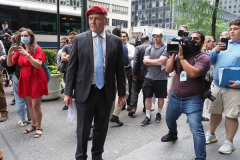 Curtis Sliwa, Republican Mayoral candidate for New York City, speaks with a woman outside the Manhattan office of New York Governor Andrew Cuomo in New York on 04 August 2021. Sliwa called for Governor Andrew Cuomo to step down amid the Attorney General's report backing up allegations that the Governor sexually harassed women.