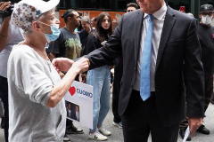 Curtis Sliwa, Republican Mayoral candidate for New York City, speaks with a woman outside the Manhattan office of New York Governor Andrew Cuomo in New York on Wednesday, Aug. 4, 2021. Sliwa called for Governor Andrew Cuomo to step down amid the Attorney General's report backing up allegations that the Governor sexually harassed women.