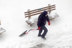December 17,2020   Snow Storm hits New York City. Kids playing in the snow and adultsshoveling snow and cleaning off cars.