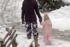 December 17,2020   Snow Storm hits New York City. Kids playing in the snow and adultsshoveling snow and cleaning off cars.