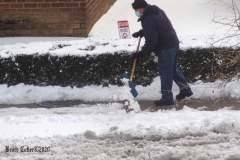 December 17,2020   Snow Storm hits New York City. Kids playing in the snow and adultsshoveling snow and cleaning off cars.