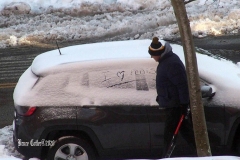 December 17,2020   Snow Storm hits New York City. Kids playing in the snow and adultsshoveling snow and cleaning off cars.