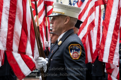 Holding a moment of silence for the victims of the 9/11 attacks, a member of the FDNY faces South towards Ground Zero during the St. Patrick's Day Parade in New York, New York, on Mar. 17, 2022. (Photo by Gabriele Holtermann/Sipa USA)