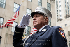 Holding a moment of silence for the victims of the 9/11 attacks, a member of the FDNY faces South towards Ground Zero during the St. Patrick's Day Parade in New York, New York, on Mar. 17, 2022. (Photo by Gabriele Holtermann/Sipa USA)