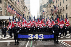 Members of the FDNY carry a banner during the St. Patrick's Day Parade in New York, New York, on Mar. 17, 2022.  The number 343 represents the firefighters killed on 9/11 and those who have died of 9/11 related illnesses. (Photo by Gabriele Holtermann/Sipa USA)