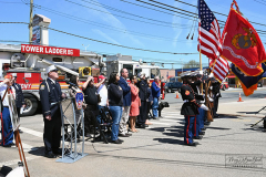 Street Naming
Lilac Court and Forest Avenue
Mariners Harbor
Staten Island, NY
April 22, 2022
Photographs by Mary DiBiase Blaich

The interaction of Lilac Court and Forest Avenue was renamed in a ceremony on Friday, April 22, 2022 for Nicholas M Troianiello, a World War II veteran of the Battle of Iwo Jima who served with the Marines.  Upon returning from service, he joined the FDNY and rose to the rank of Lieutenant, serving in Ladder 15 in Manhattan. He was a Purple Heart recipient.
At the ceremony, many groups gathered to honor Mr Troianiello including The Marine Corps League, the FDNY Retirees Association and current members of the FDNY.  Also in attendance were Congresswoman Nicole Malliotakis; Boro President Vito Fossella;  City Councilwoman Kamillah Hanks and two color guards: Marines 6th Communication Battalion and the FDNY Ceremonial Unit.  The Marine Corps League gave a 21 gun salute, and Frank Montella played Taps.  Carmella Montella needed a box to reach the microphone as she delivered the Invocation.