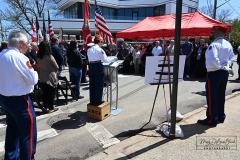 Street Naming
Lilac Court and Forest Avenue
Mariners Harbor
Staten Island, NY
April 22, 2022
Photographs by Mary DiBiase Blaich

The interaction of Lilac Court and Forest Avenue was renamed in a ceremony on Friday, April 22, 2022 for Nicholas M Troianiello, a World War II veteran of the Battle of Iwo Jima who served with the Marines.  Upon returning from service, he joined the FDNY and rose to the rank of Lieutenant, serving in Ladder 15 in Manhattan. He was a Purple Heart recipient.
At the ceremony, many groups gathered to honor Mr Troianiello including The Marine Corps League, the FDNY Retirees Association and current members of the FDNY.  Also in attendance were Congresswoman Nicole Malliotakis; Boro President Vito Fossella;  City Councilwoman Kamillah Hanks and two color guards: Marines 6th Communication Battalion and the FDNY Ceremonial Unit.  The Marine Corps League gave a 21 gun salute, and Frank Montella played Taps.  Carmella Montella needed a box to reach the microphone as she delivered the Invocation.