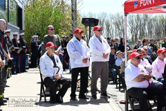 Street Naming
Lilac Court and Forest Avenue
Mariners Harbor
Staten Island, NY
April 22, 2022
Photographs by Mary DiBiase Blaich

The interaction of Lilac Court and Forest Avenue was renamed in a ceremony on Friday, April 22, 2022 for Nicholas M Troianiello, a World War II veteran of the Battle of Iwo Jima who served with the Marines.  Upon returning from service, he joined the FDNY and rose to the rank of Lieutenant, serving in Ladder 15 in Manhattan. He was a Purple Heart recipient.
At the ceremony, many groups gathered to honor Mr Troianiello including The Marine Corps League, the FDNY Retirees Association and current members of the FDNY.  Also in attendance were Congresswoman Nicole Malliotakis; Boro President Vito Fossella;  City Councilwoman Kamillah Hanks and two color guards: Marines 6th Communication Battalion and the FDNY Ceremonial Unit.  The Marine Corps League gave a 21 gun salute, and Frank Montella played Taps.  Carmella Montella needed a box to reach the microphone as she delivered the Invocation.