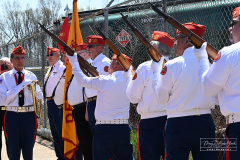 Street Naming
Lilac Court and Forest Avenue
Mariners Harbor
Staten Island, NY
April 22, 2022
Photographs by Mary DiBiase Blaich

The interaction of Lilac Court and Forest Avenue was renamed in a ceremony on Friday, April 22, 2022 for Nicholas M Troianiello, a World War II veteran of the Battle of Iwo Jima who served with the Marines.  Upon returning from service, he joined the FDNY and rose to the rank of Lieutenant, serving in Ladder 15 in Manhattan. He was a Purple Heart recipient.
At the ceremony, many groups gathered to honor Mr Troianiello including The Marine Corps League, the FDNY Retirees Association and current members of the FDNY.  Also in attendance were Congresswoman Nicole Malliotakis; Boro President Vito Fossella;  City Councilwoman Kamillah Hanks and two color guards: Marines 6th Communication Battalion and the FDNY Ceremonial Unit.  The Marine Corps League gave a 21 gun salute, and Frank Montella played Taps.  Carmella Montella needed a box to reach the microphone as she delivered the Invocation.