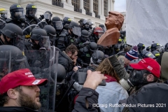 Trump supporters, one carrying a bust of Trump, face off south police on the steps of the United State Capitol in Washington, D.C., Wednesday, Jan. 6, 2020, as they protest the electoral college certification of President-Elect Joe Biden.