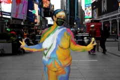 New York City. "The Crossroads of the World" Times Square. Andy Golub Artist/Founder of Human Connection Arts paints 3 models in Times square, as onlookers watch and street performers and costume characters entertainvistors.