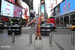 New York City. "The Crossroads of the World" Times Square. Andy Golub Artist/Founder of Human Connection Arts paints 3 models in Times square, as onlookers watch and street performers and costume characters entertainvistors.