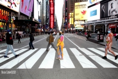 New York City. "The Crossroads of the World" Times Square. Andy Golub Artist/Founder of Human Connection Arts paints 3 models in Times square, as onlookers watch and street performers and costume characters entertainvistors.