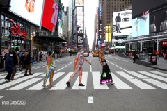 New York City. "The Crossroads of the World" Times Square. Andy Golub Artist/Founder of Human Connection Arts paints 3 models in Times square, as onlookers watch and street performers and costume characters entertainvistors.