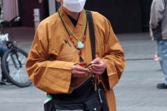 New York City. "The Crossroads of the World" Times Square. Andy Golub Artist/Founder of Human Connection Arts paints 3 models in Times square, as onlookers watch and street performers and costume characters entertainvistors.