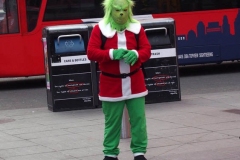 New York City. "The Crossroads of the World" Times Square. Andy Golub Artist/Founder of Human Connection Arts paints 3 models in Times square, as onlookers watch and street performers and costume characters entertainvistors.