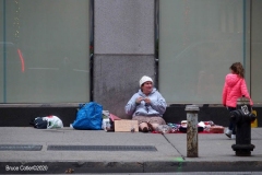 New York City. "The Crossroads of the World" Times Square. Andy Golub Artist/Founder of Human Connection Arts paints 3 models in Times square, as onlookers watch and street performers and costume characters entertainvistors.