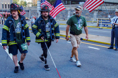The Tunnel to Tower 5k run and walk in NYC filled with runners of all kinds to commemorate the run on 9/11 of Fireman Stephen Siller from Brooklyn to Manhattan through the Hugh L. Carey tunnel.
The run pays tribute to the 343 FDNY firefighters, 71 law enforcement officers and thousands of civilians who lost their lives on that catastrophic day 20 years ago. All proceeds to the event go to supporting those of first responders and injured service members. 
Service members adorned with images of those lost and holding flags lined the streets in support of the runners as they passed through the tunnel and ran their way through lower Manhattan to the finish line. (C) Bianca Otero, September 26, 2021