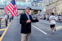 The Tunnel to Tower 5k run and walk in NYC filled with runners of all kinds to commemorate the run on 9/11 of Fireman Stephen Siller from Brooklyn to Manhattan through the Hugh L. Carey tunnel.
The run pays tribute to the 343 FDNY firefighters, 71 law enforcement officers and thousands of civilians who lost their lives on that catastrophic day 20 years ago. All proceeds to the event go to supporting those of first responders and injured service members. 
Service members adorned with images of those lost and holding flags lined the streets in support of the runners as they passed through the tunnel and ran their way through lower Manhattan to the finish line. (C) Bianca Otero, September 26, 2021
