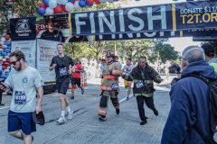 The Tunnel to Tower 5k run and walk in NYC filled with runners of all kinds to commemorate the run on 9/11 of Fireman Stephen Siller from Brooklyn to Manhattan through the Hugh L. Carey tunnel.
The run pays tribute to the 343 FDNY firefighters, 71 law enforcement officers and thousands of civilians who lost their lives on that catastrophic day 20 years ago. All proceeds to the event go to supporting those of first responders and injured service members. 
Service members adorned with images of those lost and holding flags lined the streets in support of the runners as they passed through the tunnel and ran their way through lower Manhattan to the finish line. (C) Bianca Otero, September 26, 2021