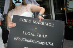 New York,   N.Y.. –Unchained At Last and advocates dressed in bridal gowns and veils, with arms chained and mouths taped, gathered in Manhattan outside Gov. Cuomo’s office to celebrate that New York just became the sixth state to end child marriage.