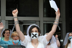 New York,   N.Y.. –Unchained At Last and advocates dressed in bridal gowns and veils, with arms chained and mouths taped, gathered in Manhattan outside Gov. Cuomo’s office to celebrate that New York just became the sixth state to end child marriage.
