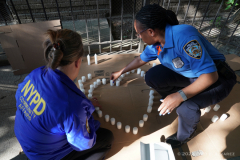 NYPD make a heart out of candles in front of building where slain Transit officer Adrianna Reyes-Gomez was killed. Bronx residents, NYPD officials and Bronx elected officials hold a Candlelight Vigil in honor and in memory of NYPD Transit Officer Adrianna Reyes-Gomez who was brutally murdered in her Bronx apartment at 780 Grand Concourse, Bronx, New York 10451 on Wednesday, June 15, 2022

Photography by Enid B. Alvarez